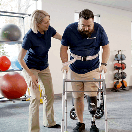 Joyce University OTA graduate working with veteran with prosthesis